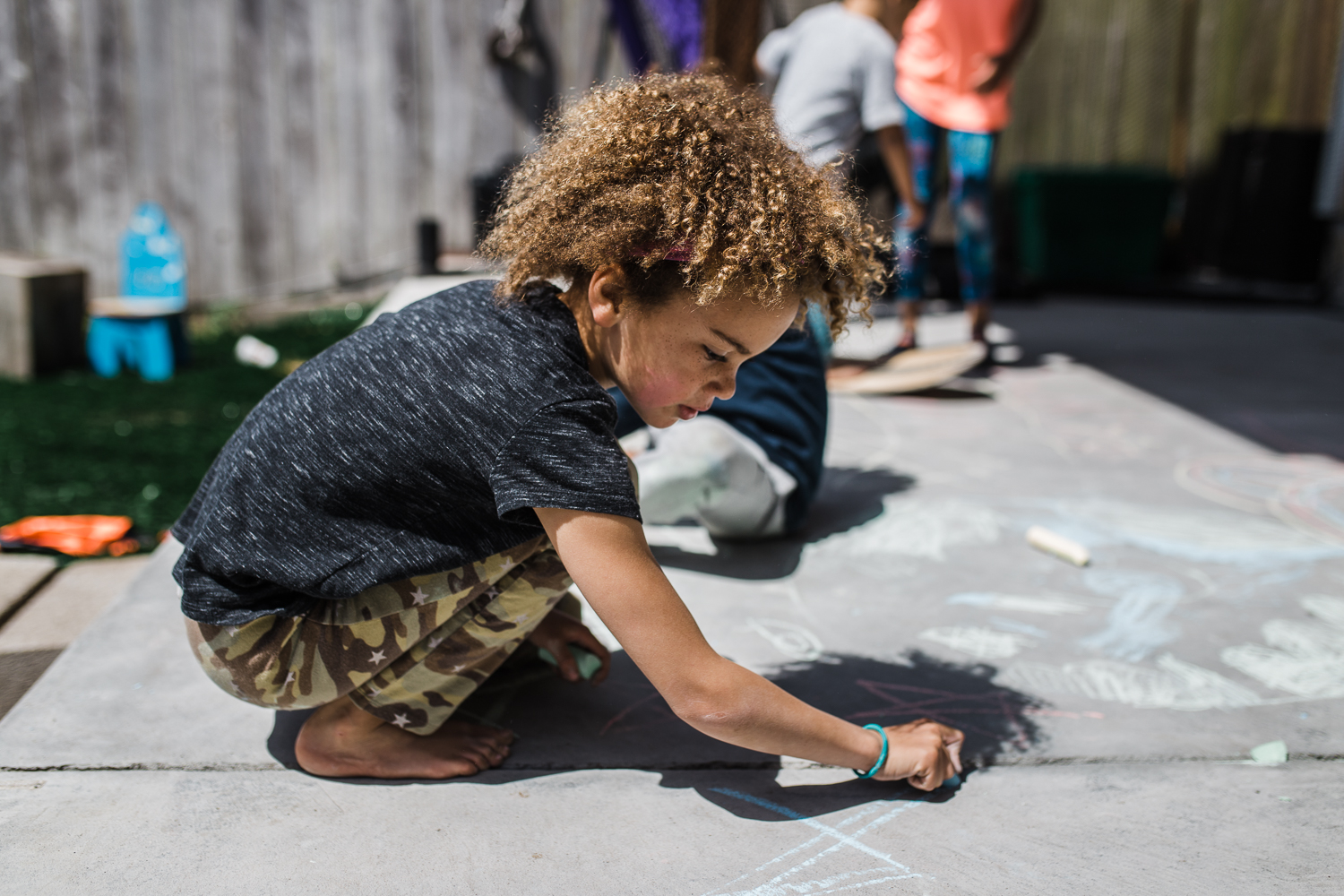 girl drawing on concrete with sidewalk chalk {San Francisco Family Photographer}