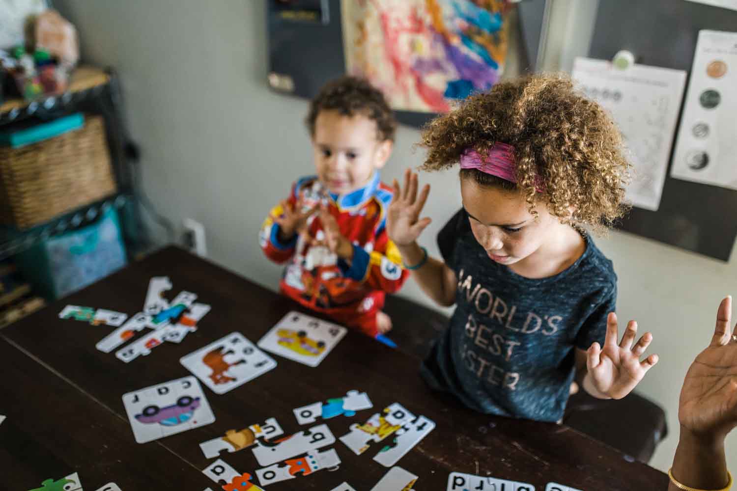 Kids playing with a puzzle at a kitchen table {San Francisco Family Photographer}