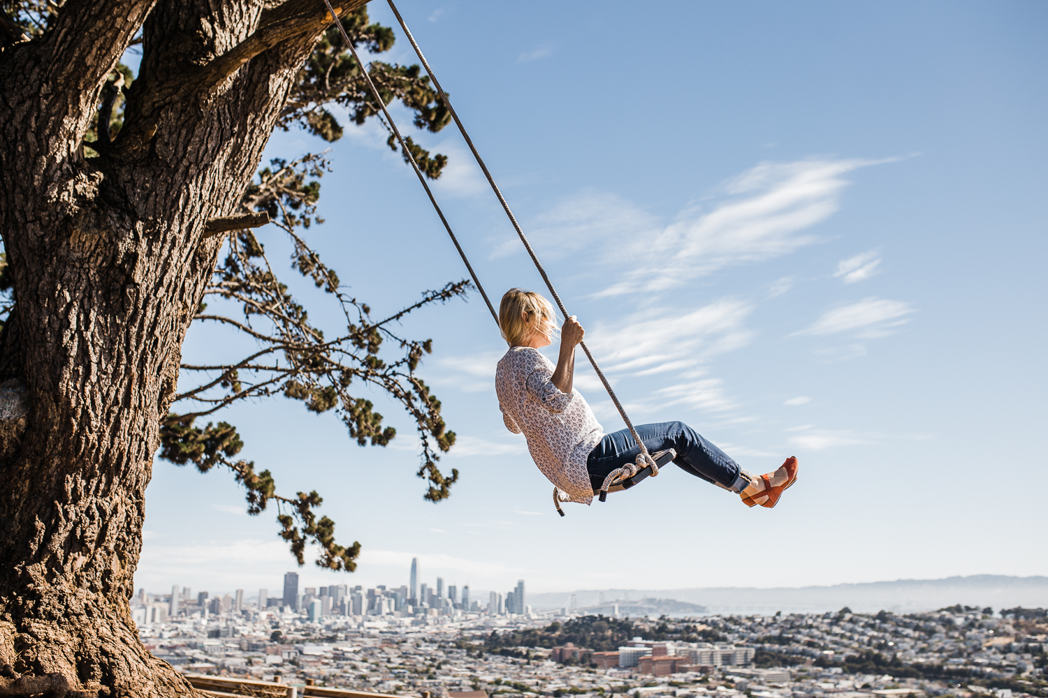 Mom swinging with a view overlooking San Francisco in the background