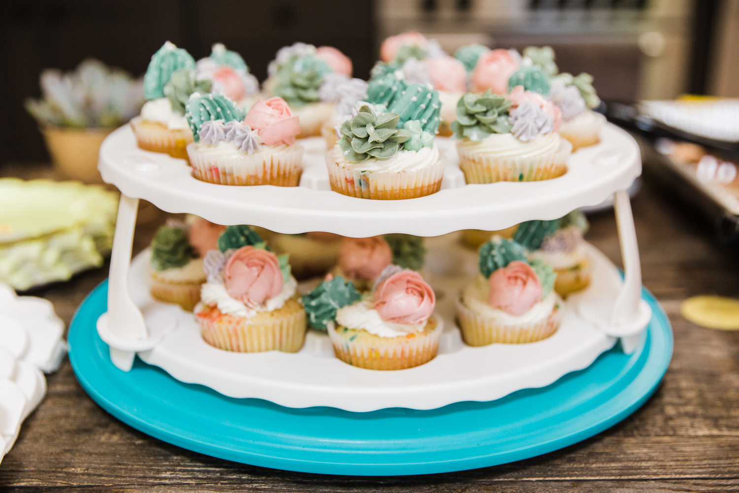 a two-tier tray of cupcakes at a gender reveal party 