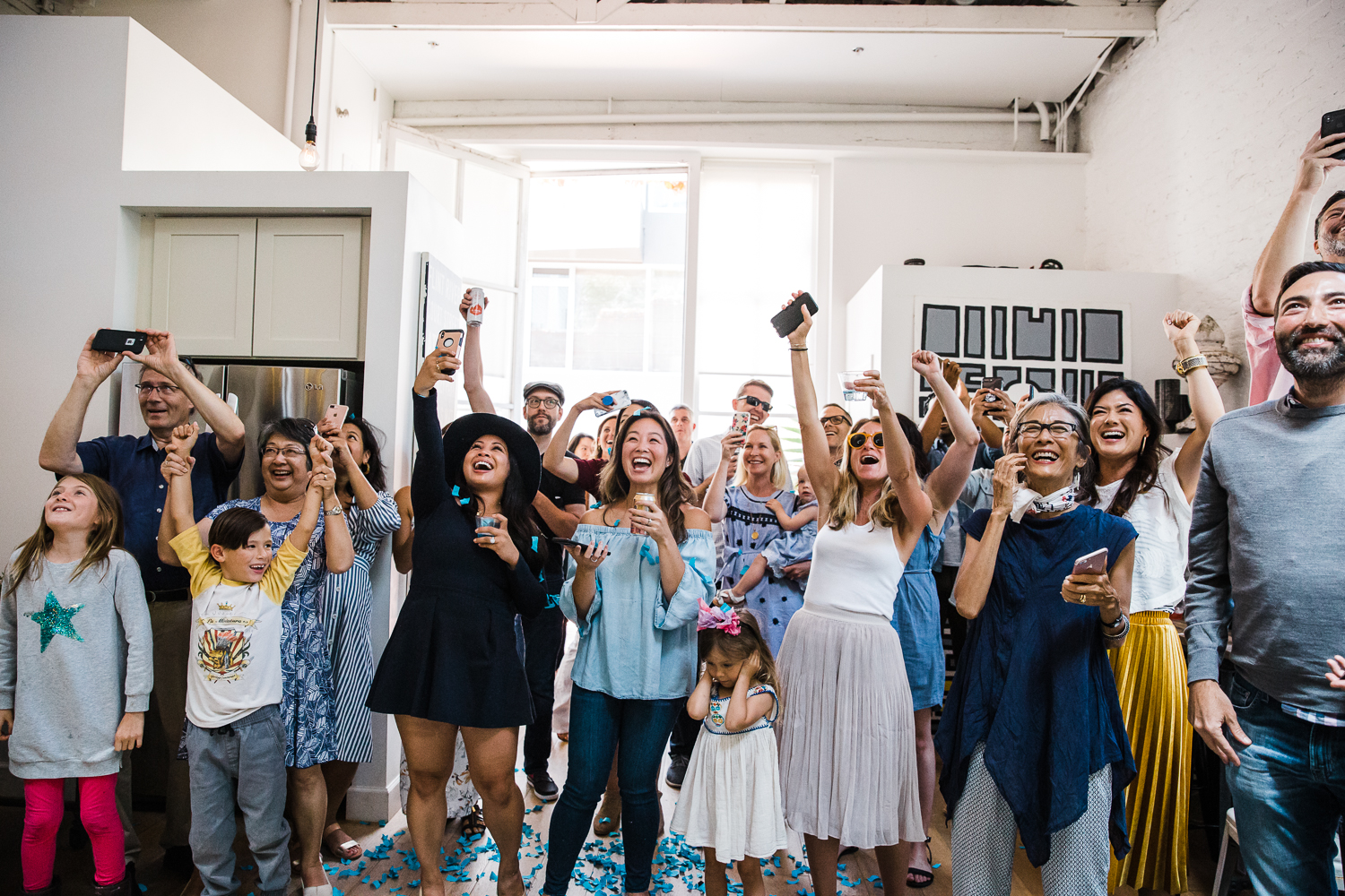 Excited family and friends celebrating when they find out it’s a boy at a gender reveal party 