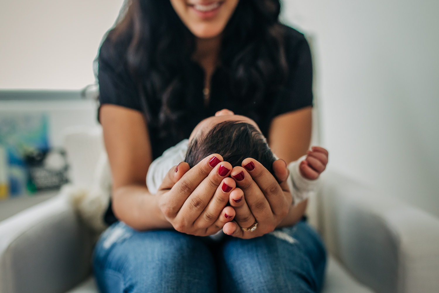 Top of baby's head as mom holds newborn baby boy in her lap | San Francisco Baby Photography