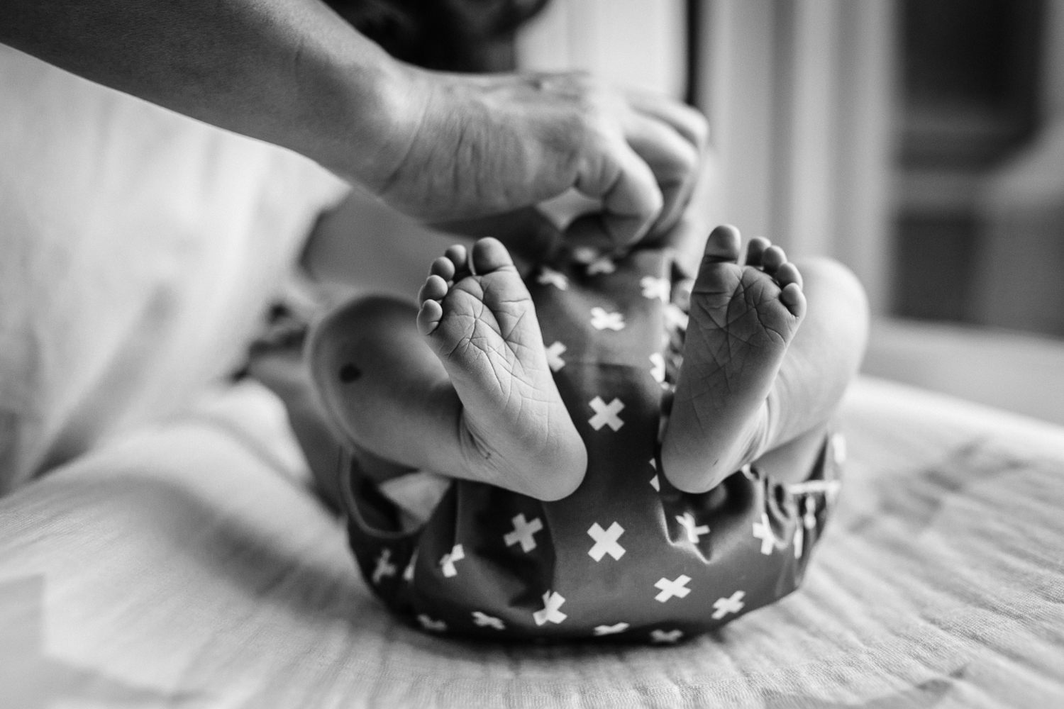 baby feet as mom changes the baby's diaper