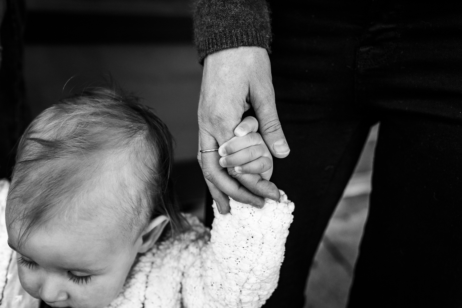 Close up of a baby holding her mom's hand while walking | San Francisco Family Photography