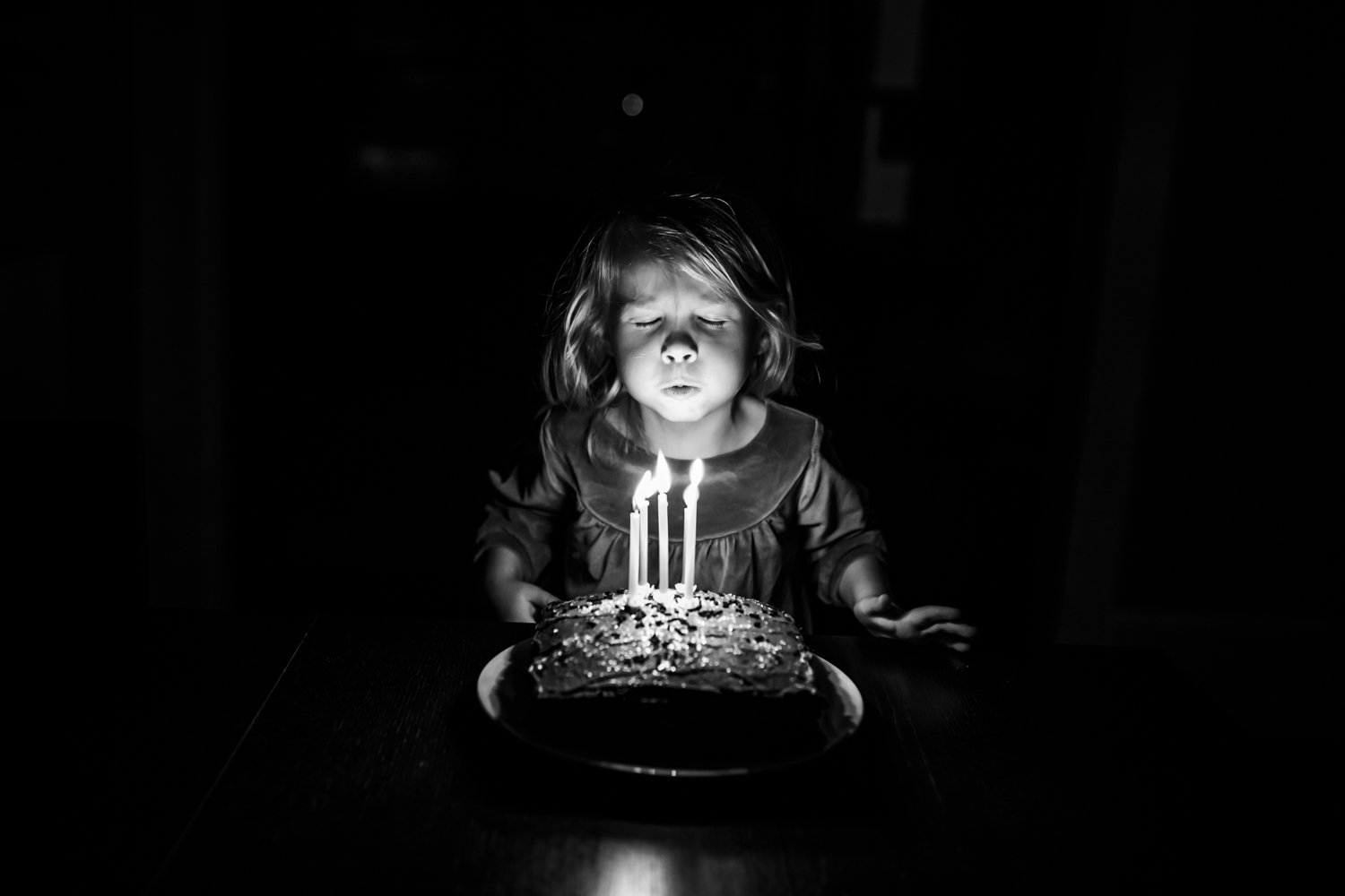 birthday girl blowing out her candles