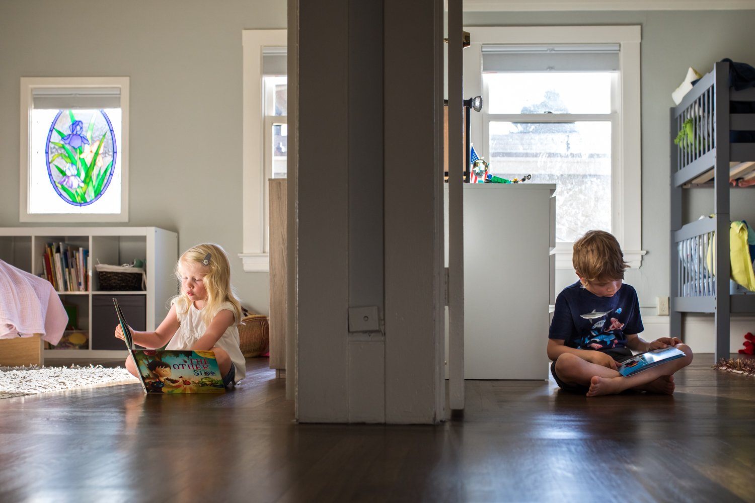 two children sitting in their rooms reading