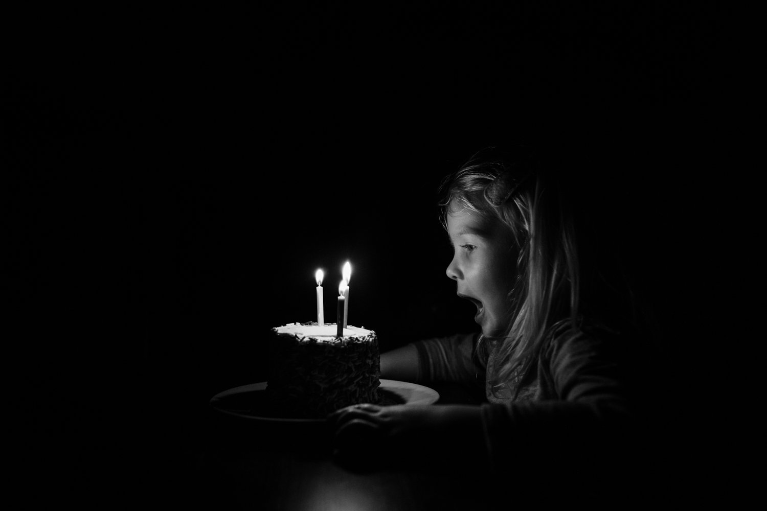 little girl excited about her birthday cake