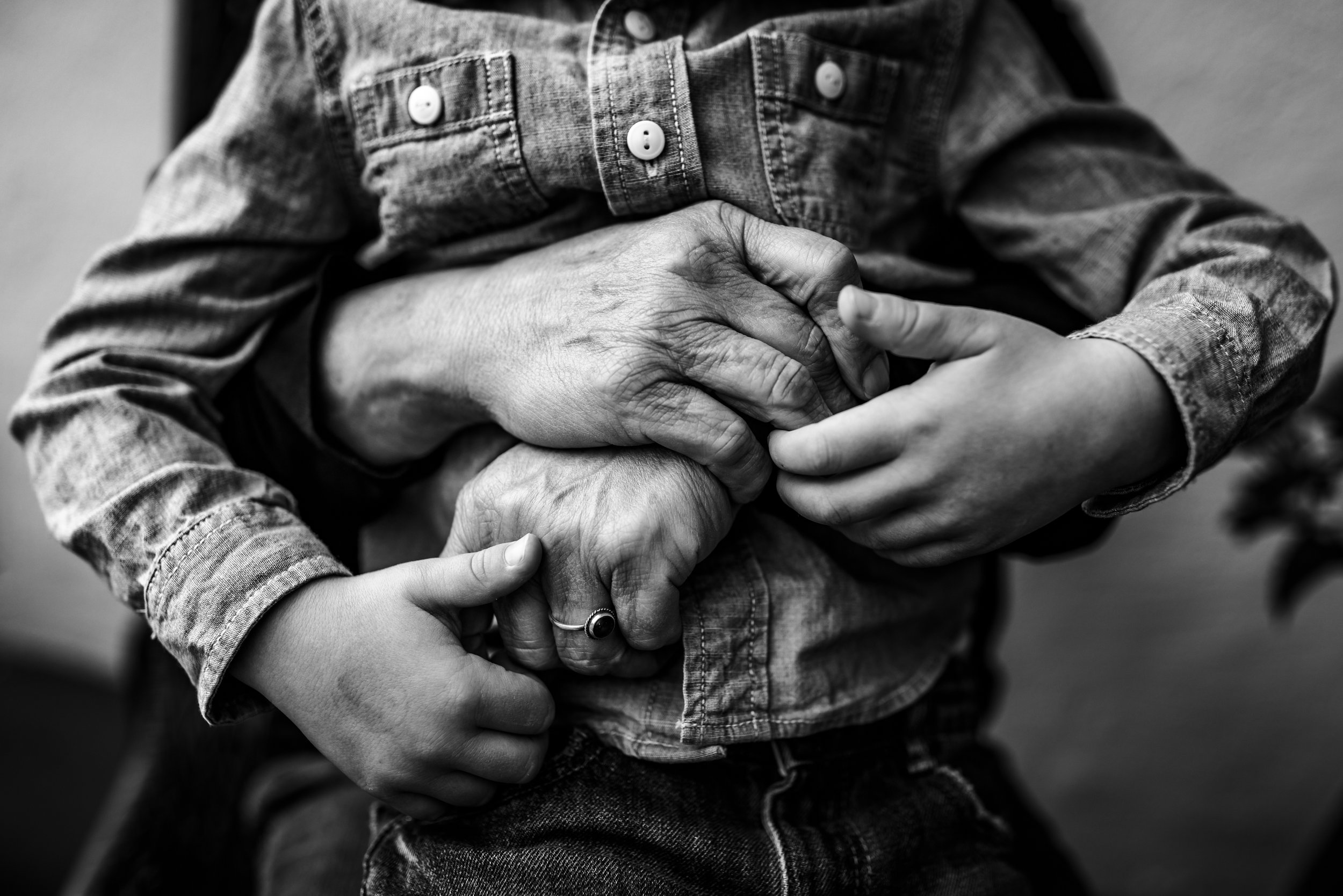 close up of grandmother's arms embracing grandson during outdoor Bay Area family session.jpg