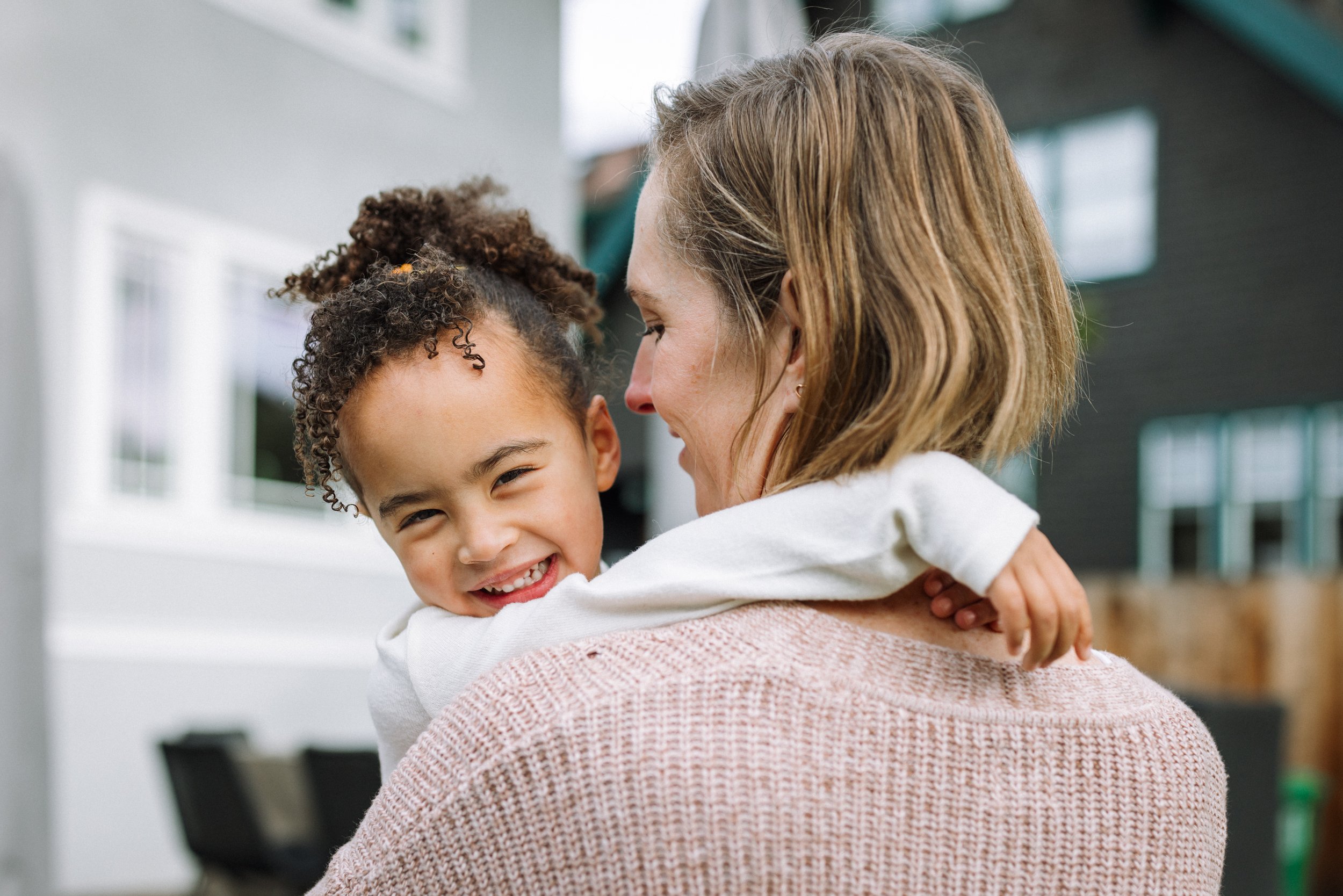 girl-laughing-as-mom-holds-her.jpg