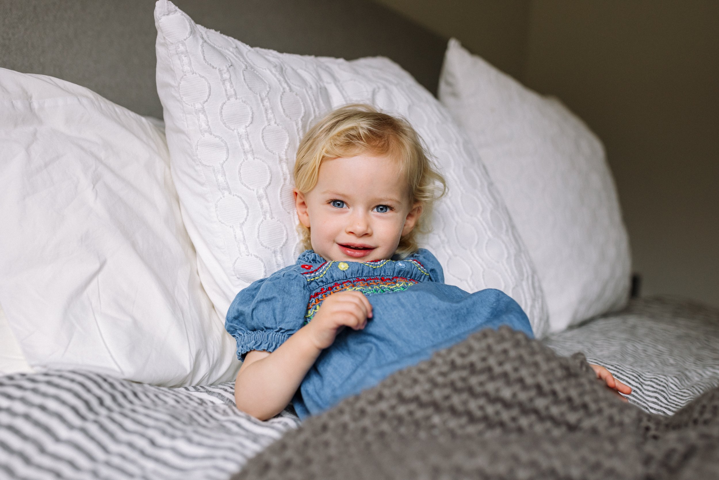 portrait-of-girl-laying-in bed-smiling.jpg