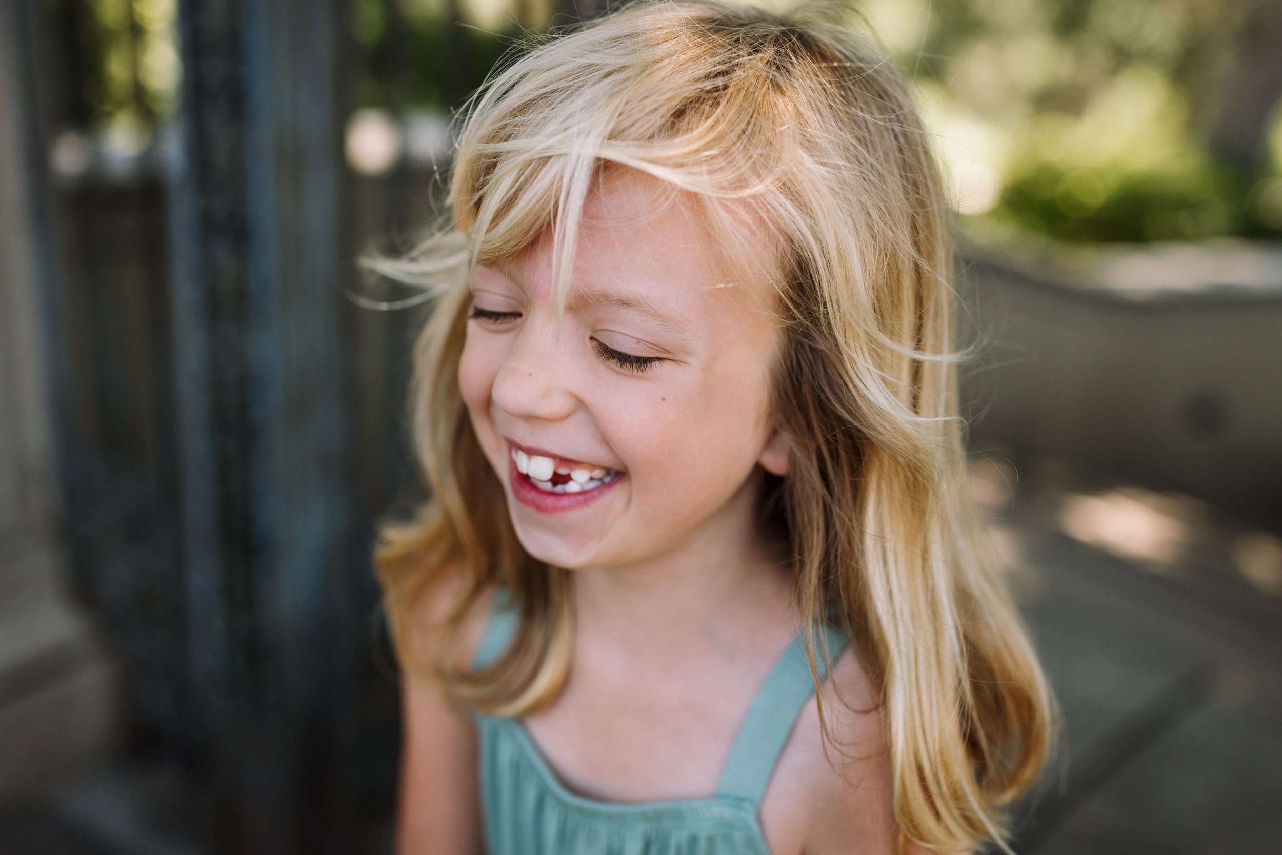 portrait-of-girl-with-eyes-closed-and-laughing