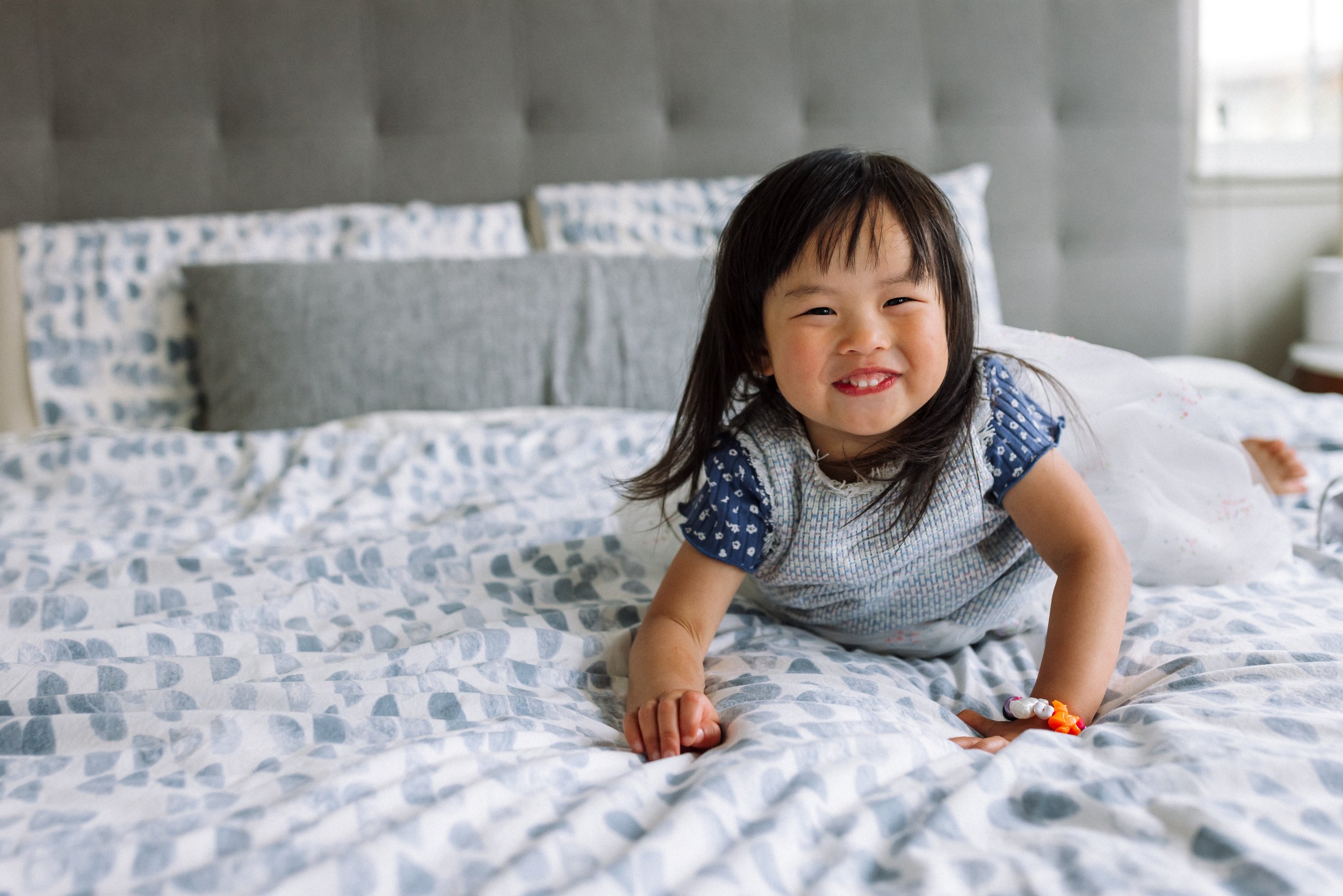 Girl-laying on-a-bed-laughing.jpg