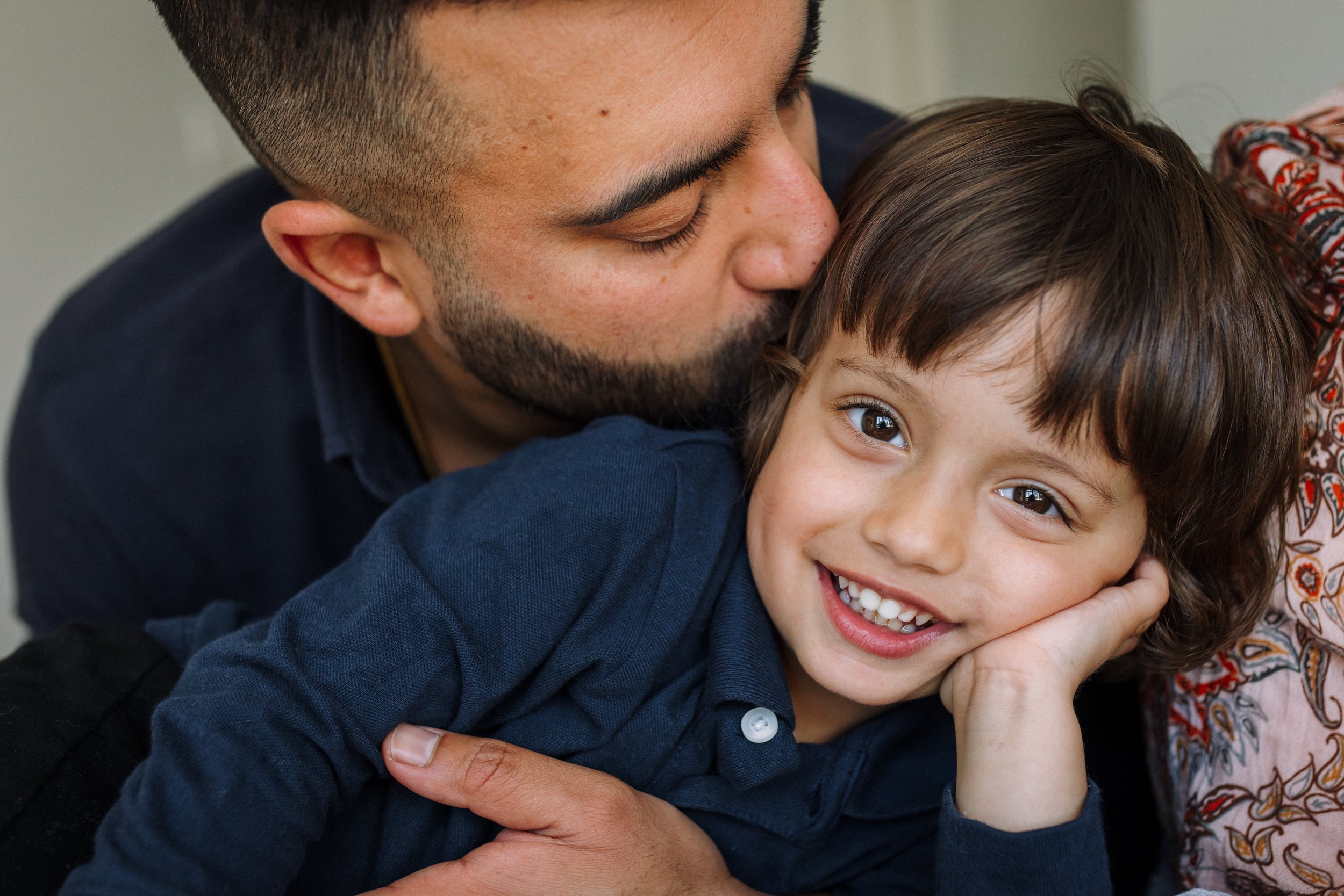 father-kissing-smiling-son.jpg