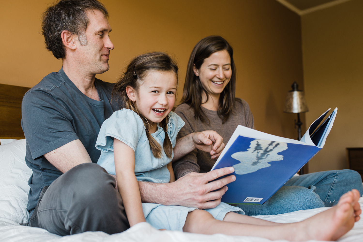 sitting-on-bed-together-reading-a-book.jpg.