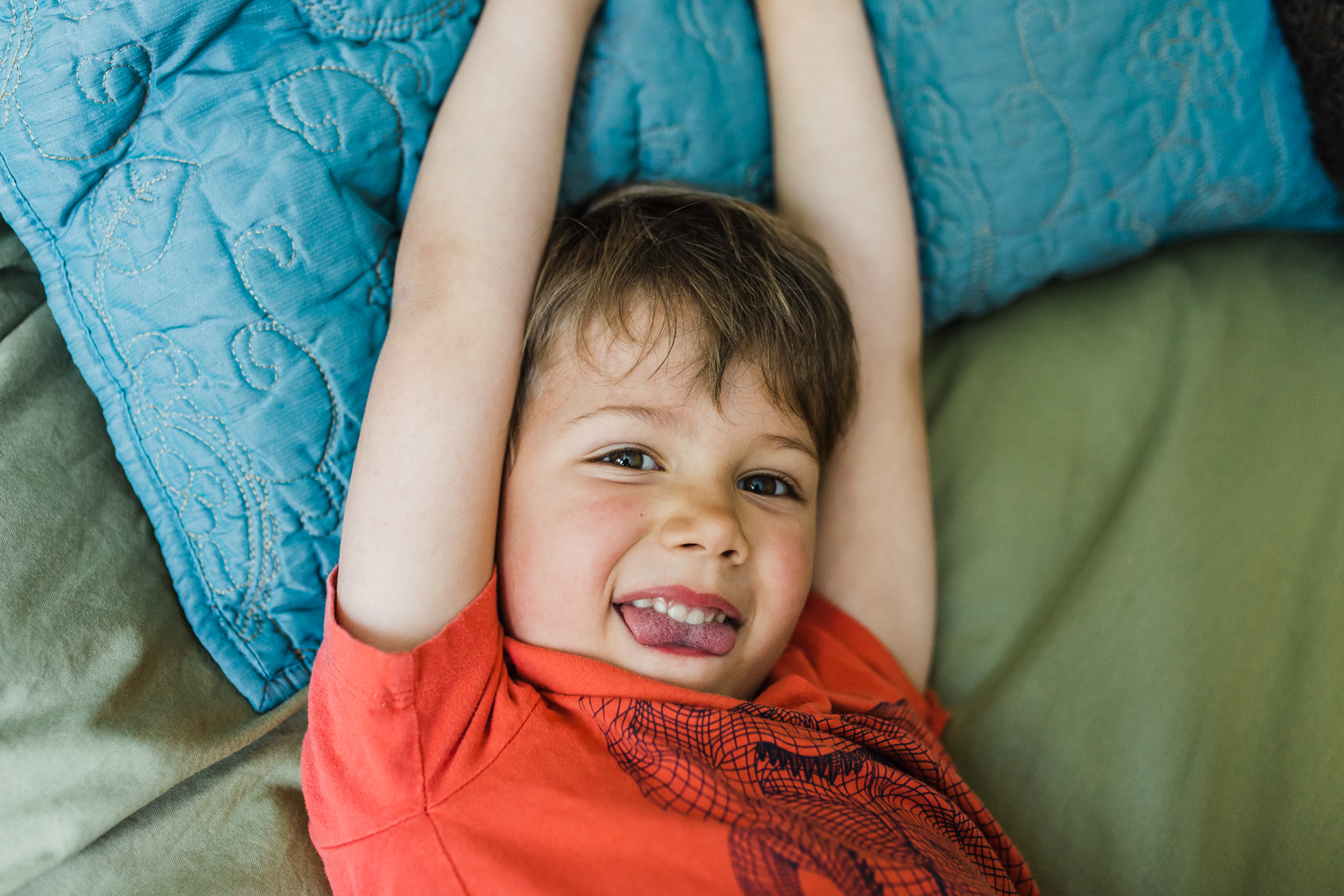 portrait-of-boy-laying-in-bed-stretching.jpg