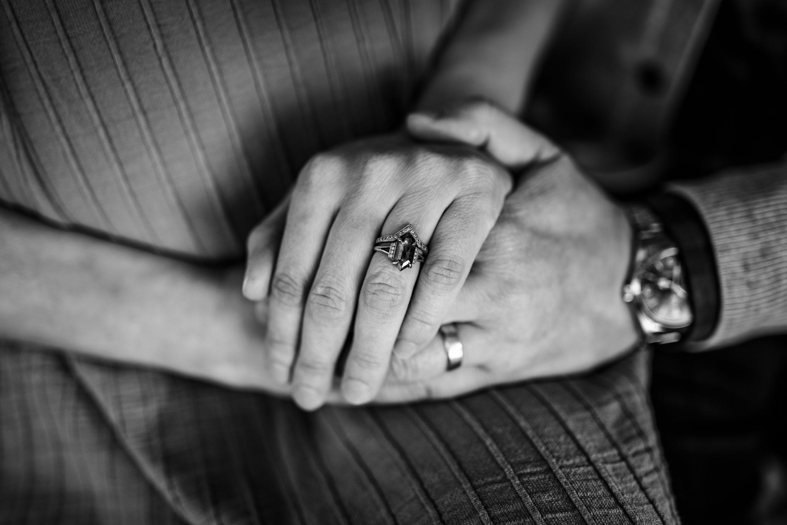 close up of married couple's hands holding with their wedding bands on