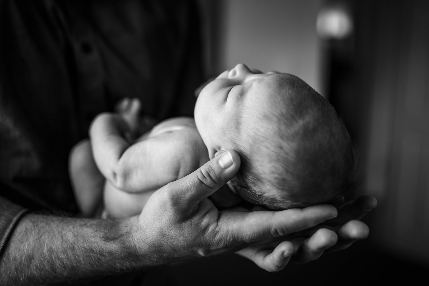 baby-held-in-Dad's-hands