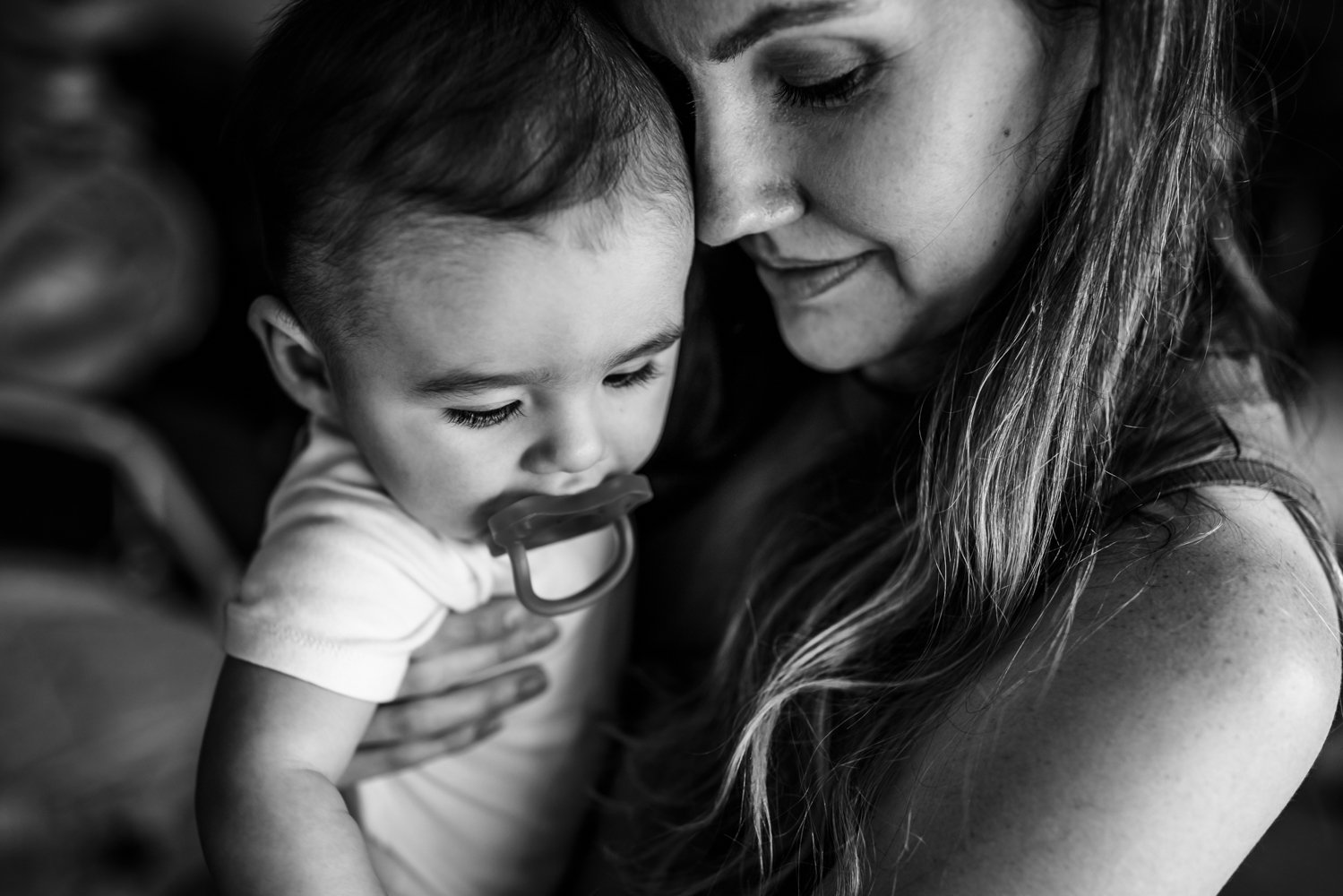 mom-snuggling-baby-with-pacifier.jpg