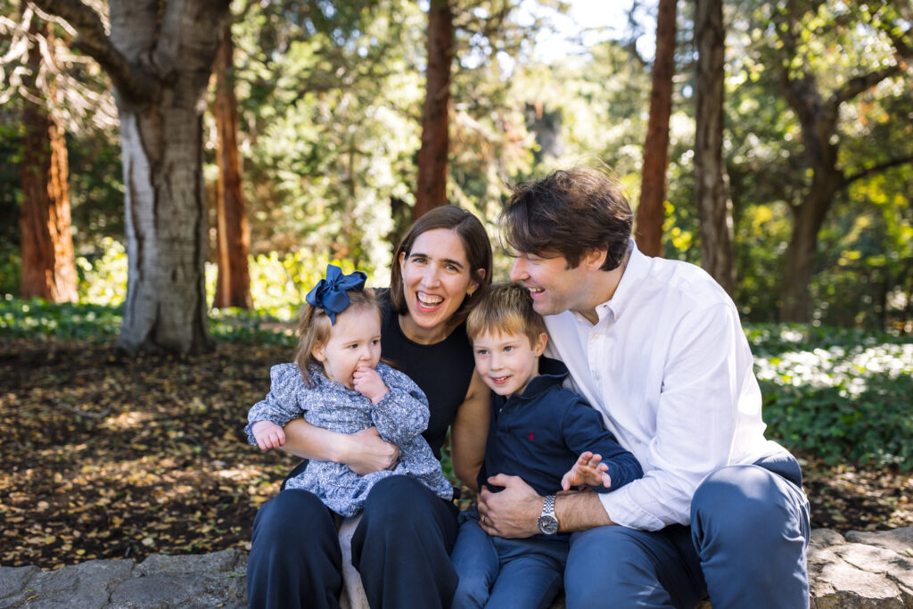 Family smiling and snuggling together in Piedmont Park