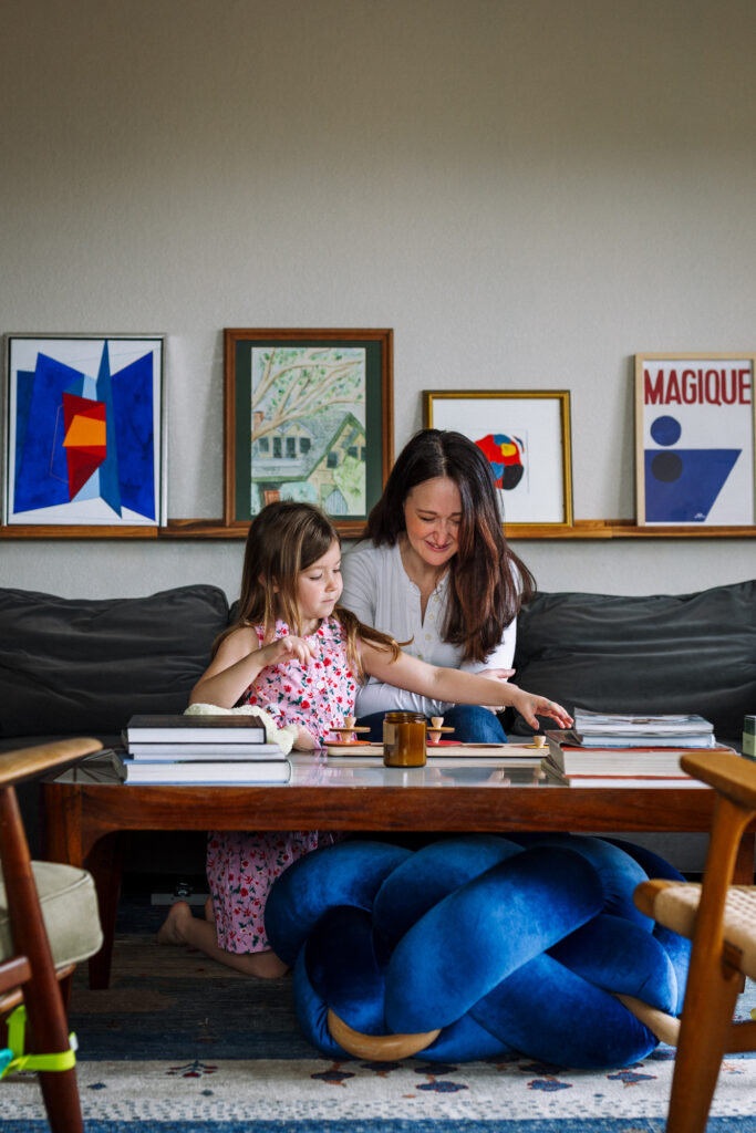 Mother and daughter playing a game together during an at-home photo session