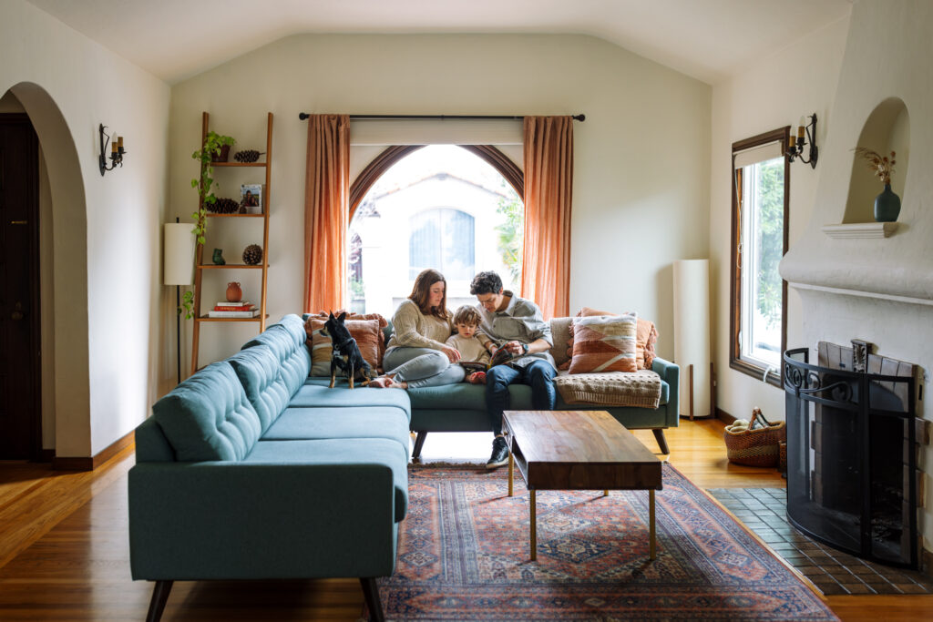 Family sitting together on the couch in a bright, inviting living room
