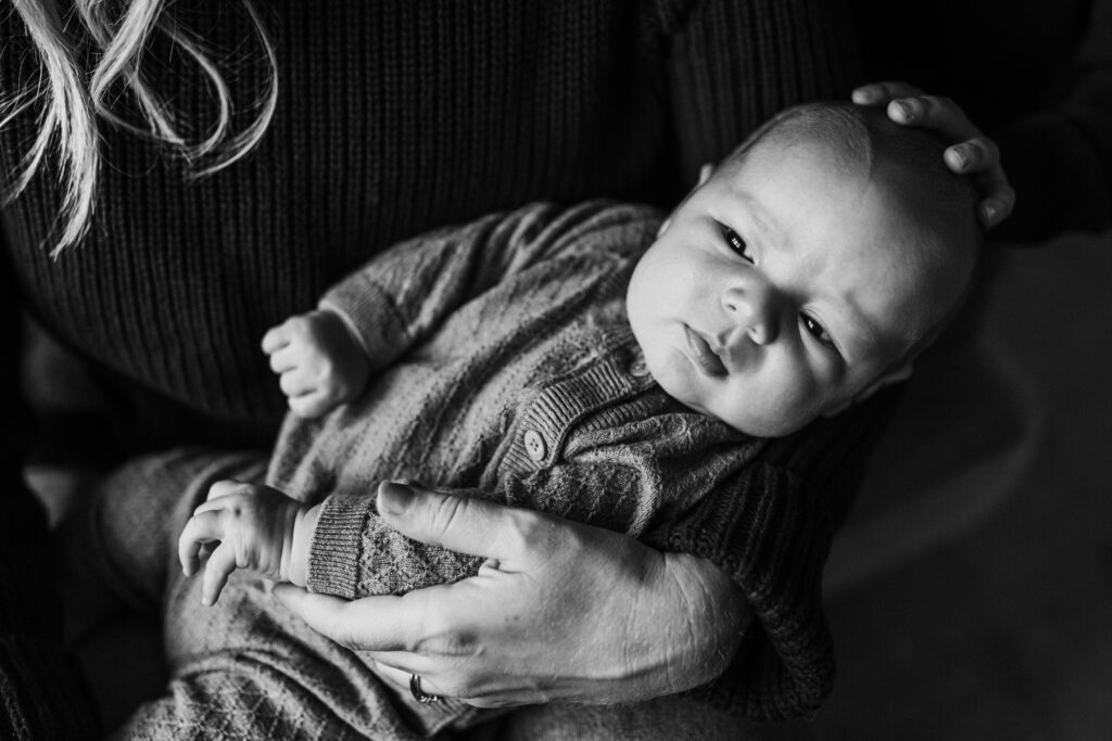 newborn being held close in-home newborn photography East Bay