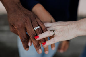 Close-up of parents' wedding rings during a family photography session at the Alameda Naval Base