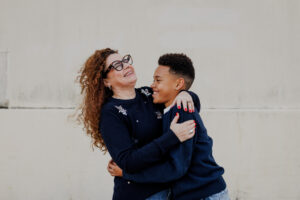 Mom and son laughing together in a close-up shot during a relaxed East Bay family session