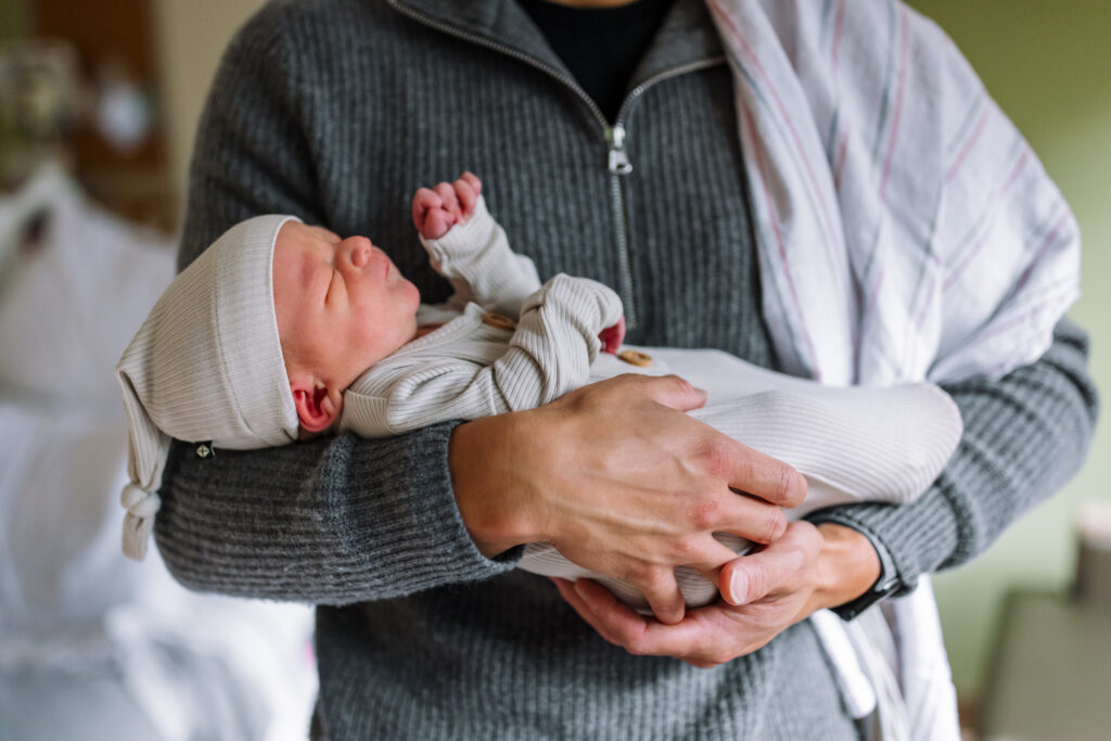 parent holding swaddled newborn in hospital Alta Bates Fresh 48 session