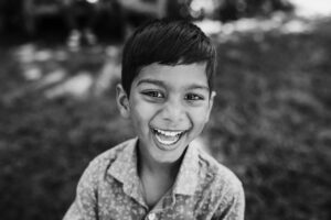 Close-up portrait of a boy laughing at the UC Botanical Garden in Berkeley