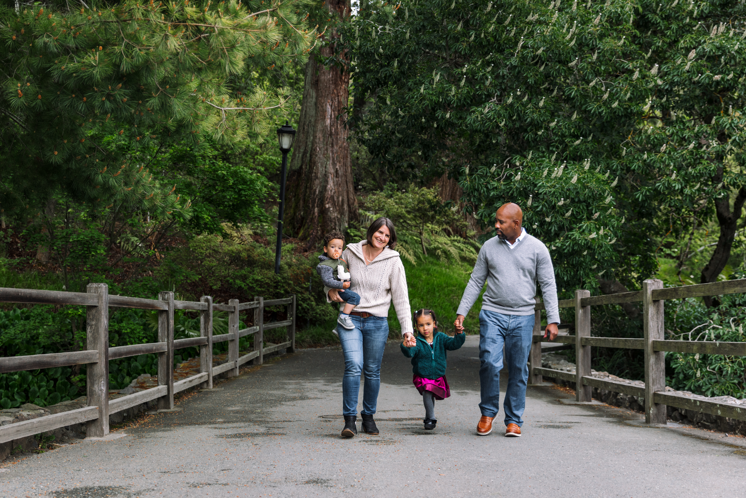 family of four walking together down path at UC Botanical Garden in Berkeley